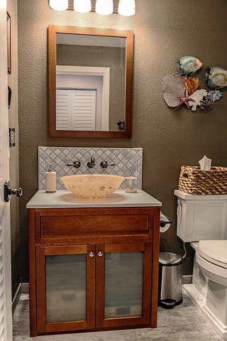 Bathroom single vanity with vessel sink.