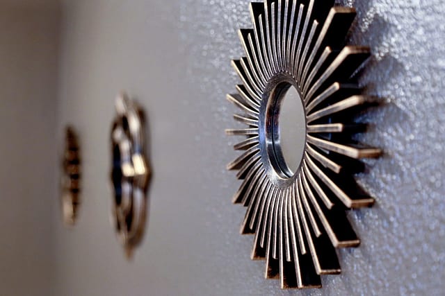 Sunburst framed mini-mirrors with gold tones on master bath walls.